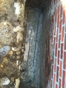 Escavated down to the base of the fireplace footing and and poured concrete to stabilize a chimney that was pulling away from the house Cherryhill Nj